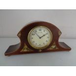 An early twentieth century inlaid Swiss mantel clock on brass feet