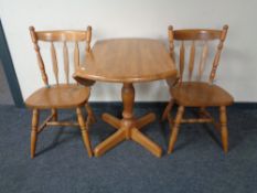 A rubber wood drop leaf kitchen table and two chairs