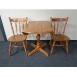 A rubber wood drop leaf kitchen table and two chairs