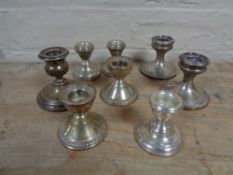 A box of silver candlesticks