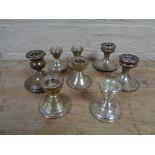 A box of silver candlesticks