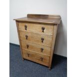 An Edwardian oak four drawer chest