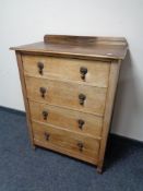 An Edwardian oak four drawer chest