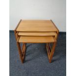 A nest of three teak tables