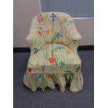 A 19th century lady's chair on oak legs with floral loose cover