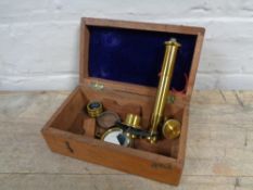 A miniature brass microscope in fitted box