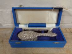 A cased silver backed baby brush with silver edged comb in fitted box