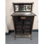 A 19th century mahogany and brass mirrored back music cabinet fitted a drawer and three internal