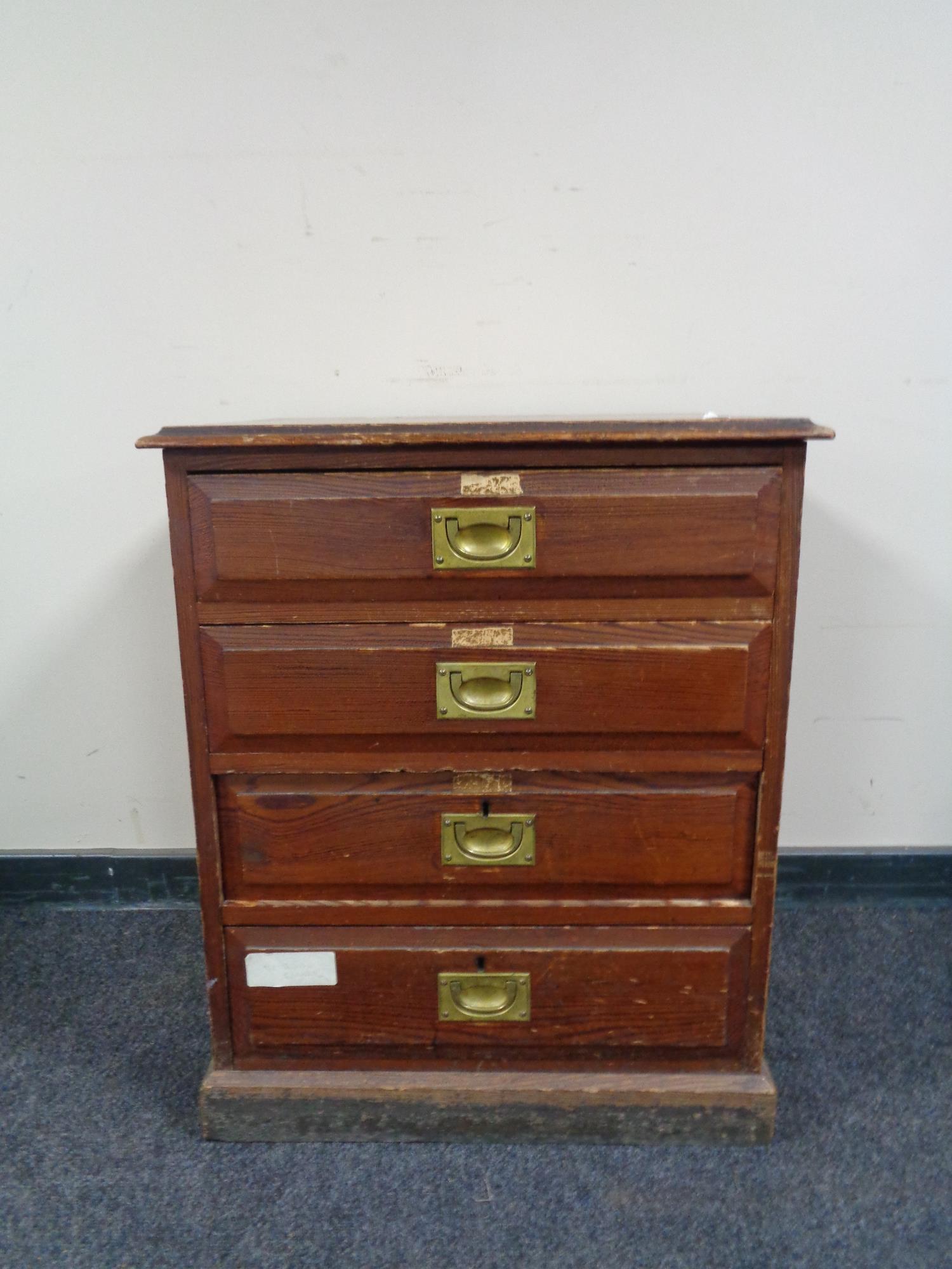 An Edwardian pine four drawer chest with brass drop handles