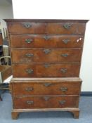 A George II walnut seven drawer chest on chest with brass drop handles