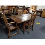 An oak pull out dining table and four chairs