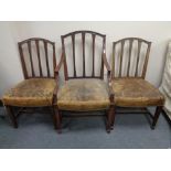 A set six Victorian mahogany rail backed dining chairs with leather upholstered seats