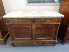A 19th century French oak double door washstand with white marble top CONDITION REPORT: