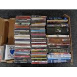 A box of DVDs and CDs including Breaking Bad box set, The Good Wife, The Doors,