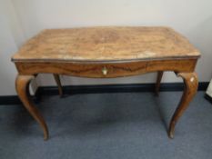 A 19th century French walnut marquetry table on cabriole legs fitted with a drawer and plate glass