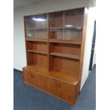 A teak G Plan display unit fitted with four cupboards