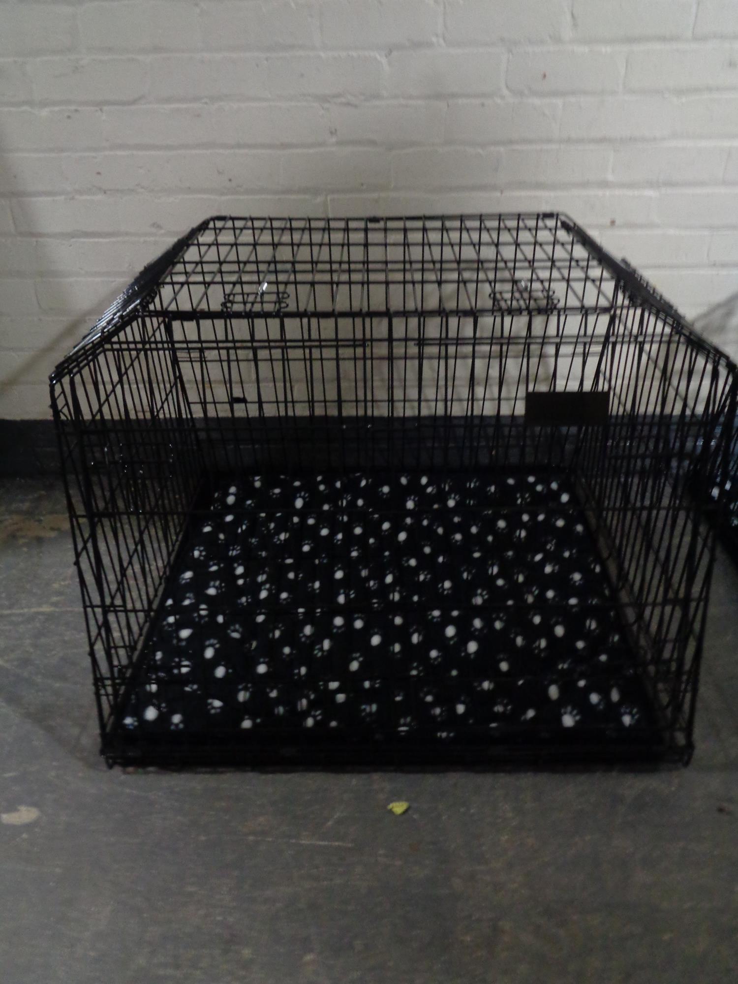 A folding dog cage, with divider,