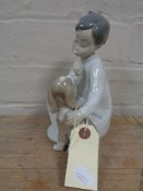 A Lladro figure number 4522 - boy with puppy