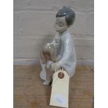 A Lladro figure number 4522 - boy with puppy