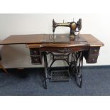 A 20th century Jones treadle sewing machine in oak table