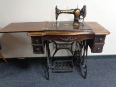 A 20th century Jones treadle sewing machine in oak table