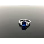 A Sterling silver Art Deco style emerald cut ring set with a blue stone, size N.