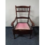 An Edwardian commode armchair