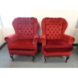 A pair of 20th century wing back armchair in red dralon