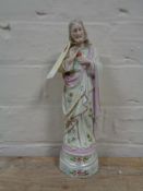 A gilt porcelain figure of Jesus