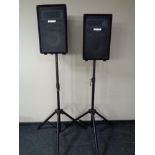 A pair of pro sound PA speakers on tripod stands