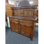 An Ercol elm buffet back sideboard