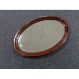 A Victorian inlaid mahogany oval bevelled edge mirror