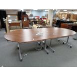 A contemporary four section boardroom table on wheels fitted with power points,