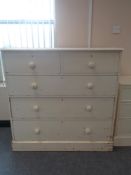 A Victorian painted pine five drawer chest with brass drop handles