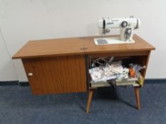 A New Home electric sewing machine in cabinet with accessories