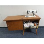 A New Home electric sewing machine in cabinet with accessories