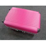 A pink hard shell luggage case
