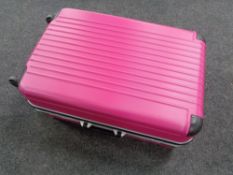 A pink hard shell luggage case