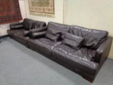 A brown leather three seater settee with matching two seater settee