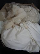 A vintage wedding dress and veil in box
