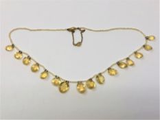 An antique citrine and pearl necklace with gold clasp