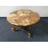 A shaped onyx coffee table on a brass base