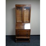 A 1930's oak bureau bookcase