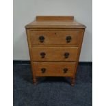 An Edwardian oak three drawer chest