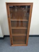 A stained plywood glazed door bookcase