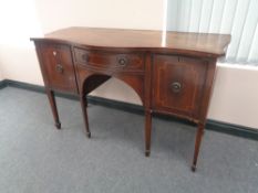 A George III inlaid mahogany serpentine fronted sideboard on raised legs with plate glass top