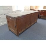 An early 19th century pine farmhouse kitchen table fitted with proving cupboard and three drawers