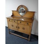 An early 20th century oak mirror backed sideboard