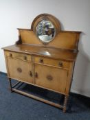 An early 20th century oak mirror backed sideboard