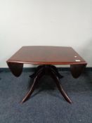 A Stag Minstrel flap sided pedestal coffee table